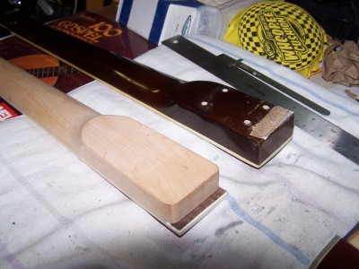 New and old.  Old neck deeper and fret board flush.